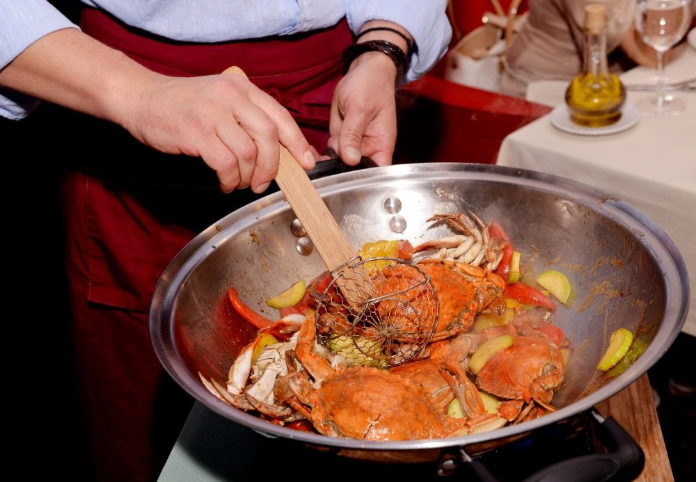 A chef cooking a crab dish